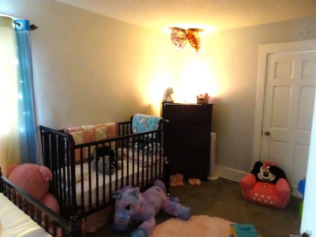 bedroom with a nursery area and baseboards