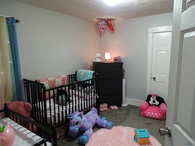 bedroom with carpet flooring, a textured ceiling, and baseboards