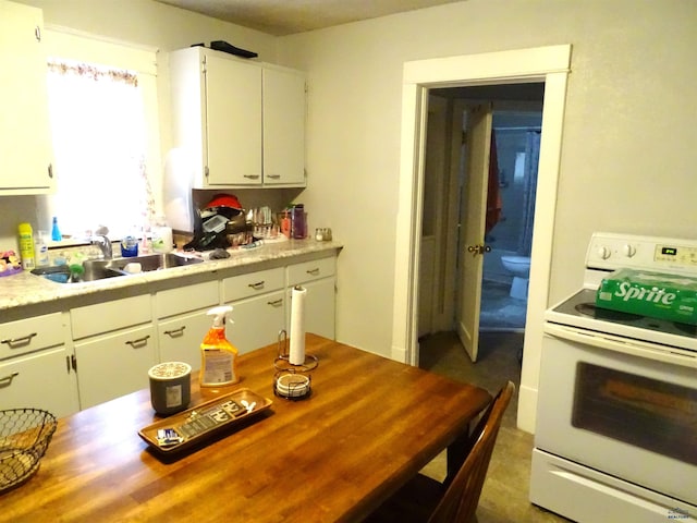 kitchen featuring white cabinets, light countertops, a sink, and white electric range oven