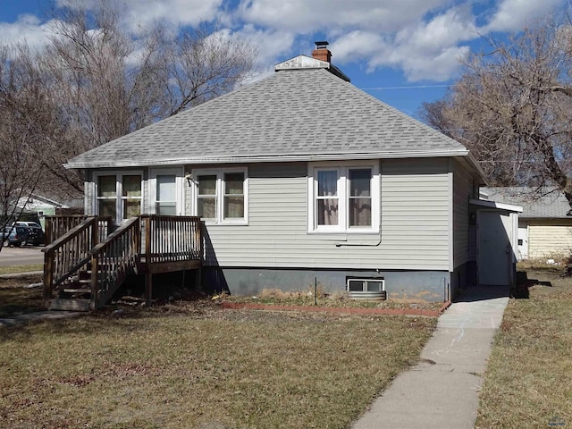 300 E Adams, Rapid City, SD 57701 - view of front facade featuring a chimney, roof with shingles, and a front yard