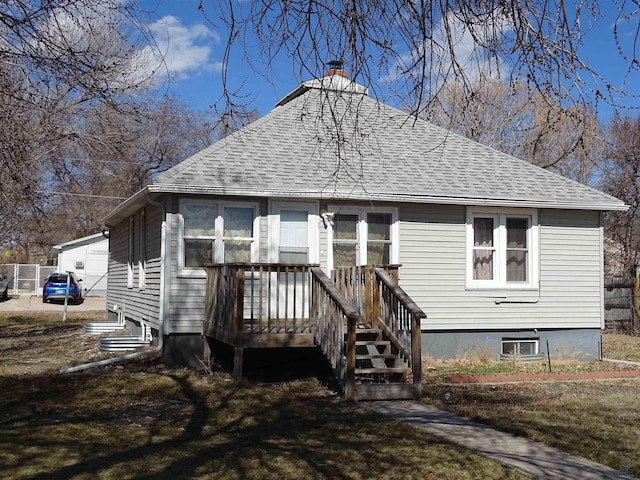 300 E Adams, Rapid City, SD 57701 - bungalow featuring a deck, a chimney, a front yard, and a shingled roof