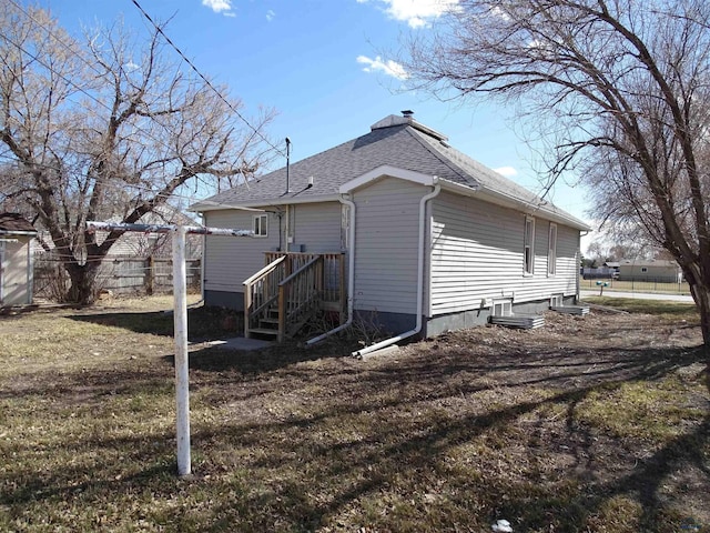 300 E Adams, Rapid City, SD 57701 - exterior space featuring a yard, fence, and a shingled roof