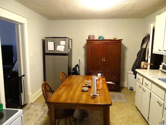 dining room with a textured ceiling