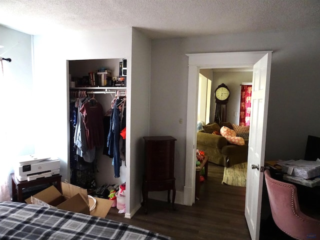 bedroom featuring a textured ceiling, a closet, and wood finished floors