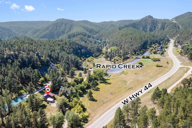 drone / aerial view with a mountain view and a view of trees