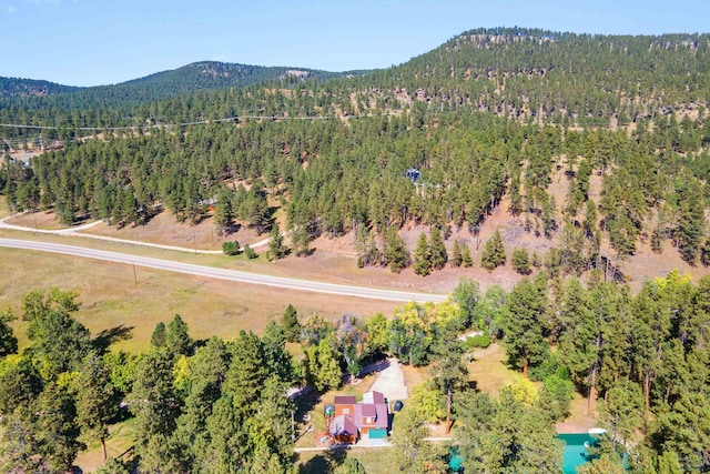 bird's eye view with a forest view and a mountain view