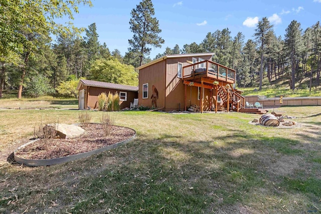 exterior space featuring a yard, a wooden deck, and stairs