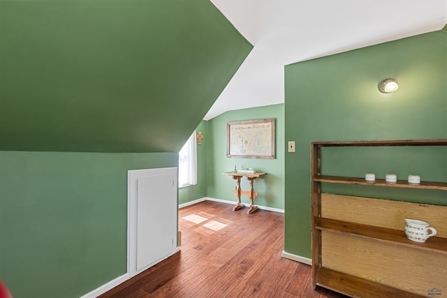 additional living space featuring lofted ceiling, wood finished floors, and baseboards