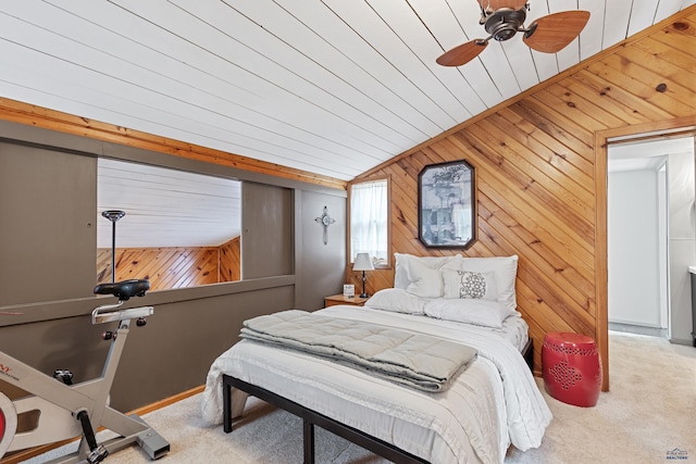 carpeted bedroom featuring a ceiling fan, lofted ceiling, and wood walls