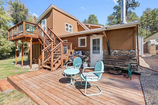 wooden deck with stairway and grilling area