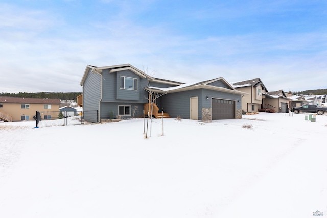 view of front of property with a garage and fence