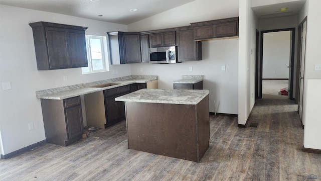 424 Yelner Dr Lot 38Blk 4, Box Elder, SD 57719 - kitchen featuring stainless steel microwave, wood finished floors, dark brown cabinets, baseboards, and lofted ceiling