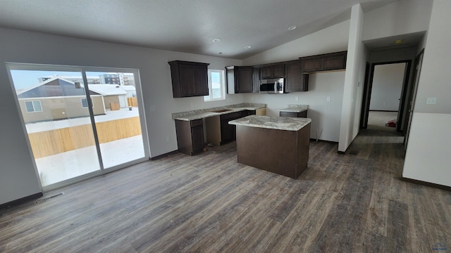 424 Yelner Dr Lot 38Blk 4, Box Elder, SD 57719 - kitchen with stainless steel microwave, dark brown cabinets, dark wood-style flooring, plenty of natural light, and vaulted ceiling