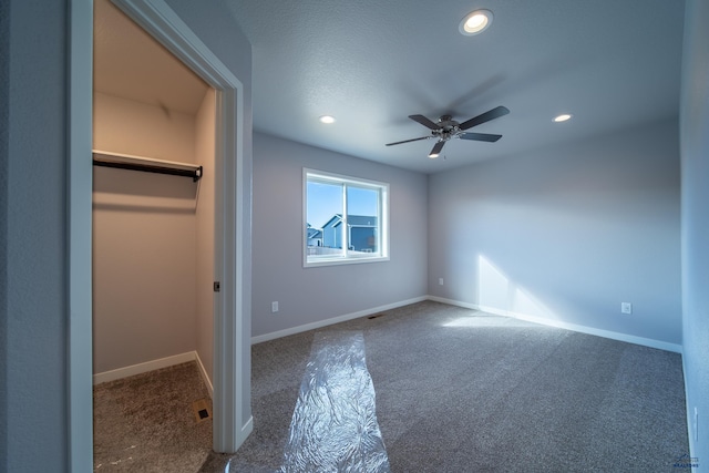 unfurnished bedroom with carpet floors, a spacious closet, recessed lighting, and baseboards