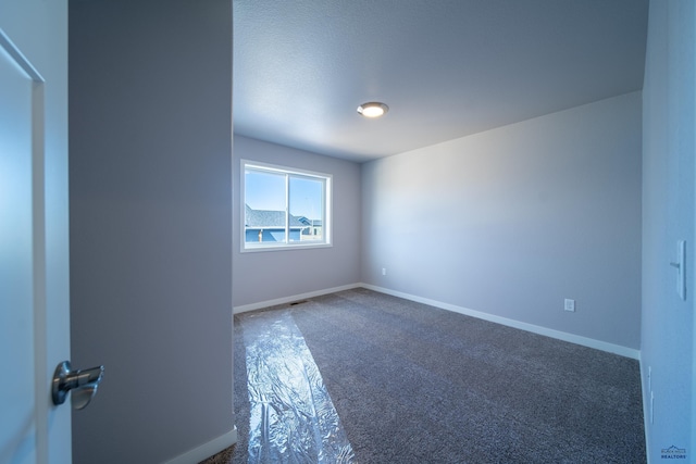 spare room featuring baseboards