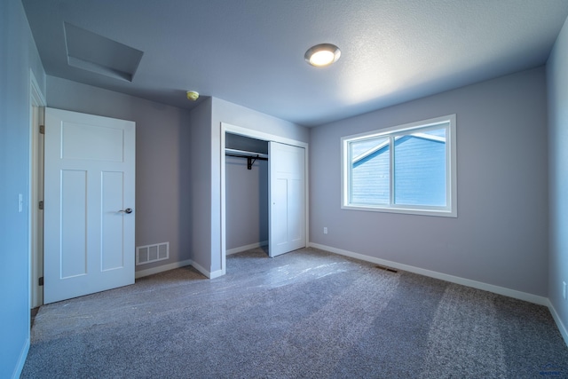 unfurnished bedroom with a closet, visible vents, baseboards, and carpet flooring