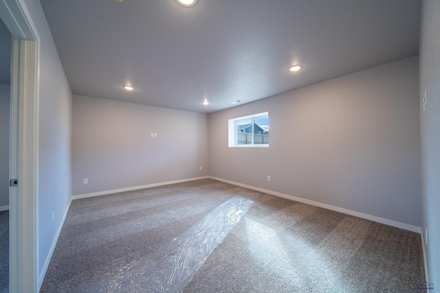 empty room featuring baseboards and recessed lighting