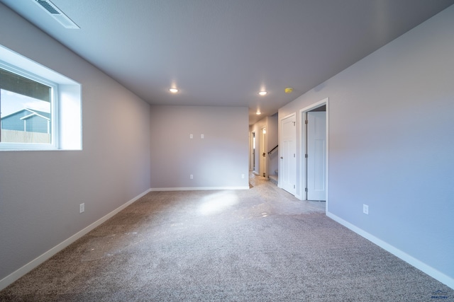 carpeted empty room with recessed lighting, visible vents, and baseboards