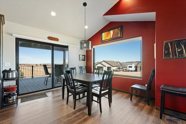 dining area with lofted ceiling, baseboards, recessed lighting, and wood finished floors