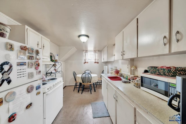 kitchen featuring white appliances, light countertops, under cabinet range hood, white cabinetry, and a sink