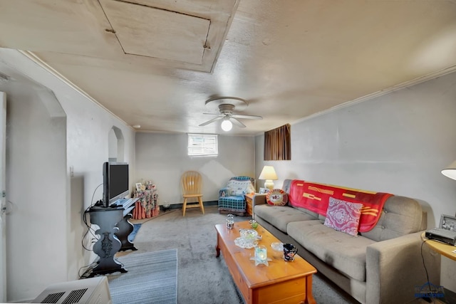 carpeted living area featuring ornamental molding and arched walkways