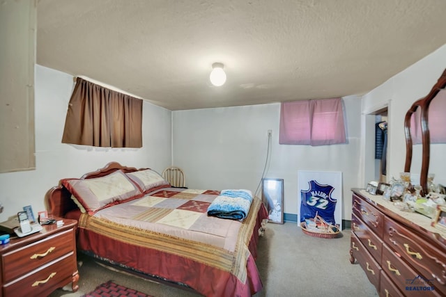 bedroom with carpet floors and a textured ceiling