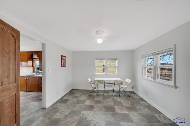 dining area featuring a ceiling fan and baseboards