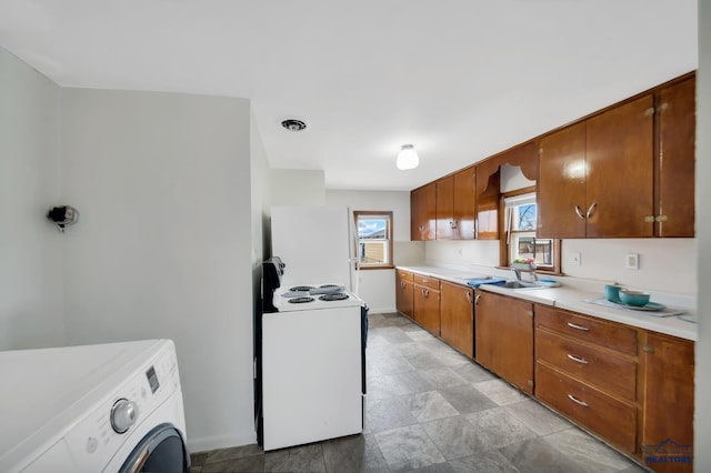 kitchen featuring washer / dryer, white appliances, brown cabinetry, light countertops, and a sink