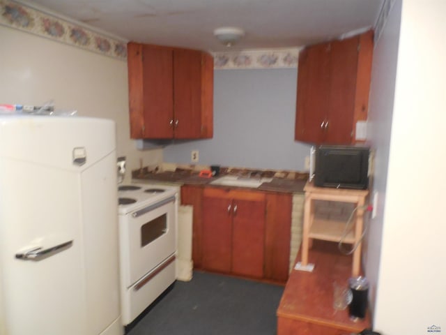 kitchen with brown cabinetry, refrigerator, and white electric stove