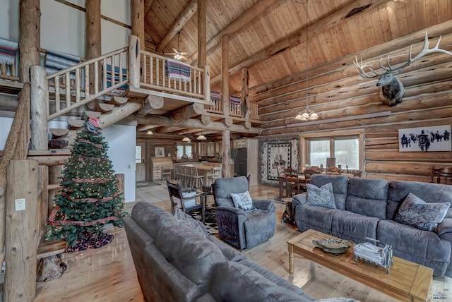 living room with high vaulted ceiling, beam ceiling, stairs, wood-type flooring, and wooden ceiling