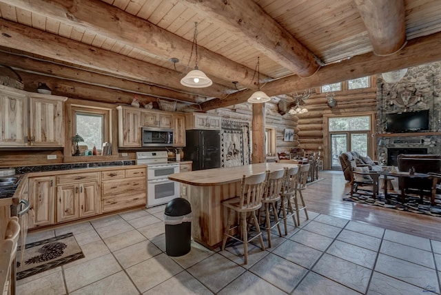 kitchen featuring double oven range, stainless steel microwave, open floor plan, freestanding refrigerator, and wood ceiling