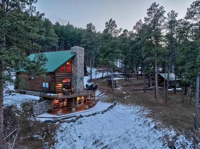 yard covered in snow with a wooded view