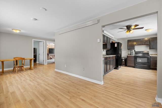 kitchen featuring baseboards, light wood finished floors, black appliances, light countertops, and dark brown cabinetry