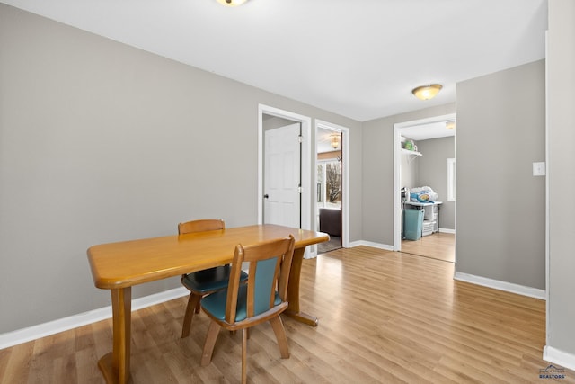 dining room featuring baseboards and light wood-style floors