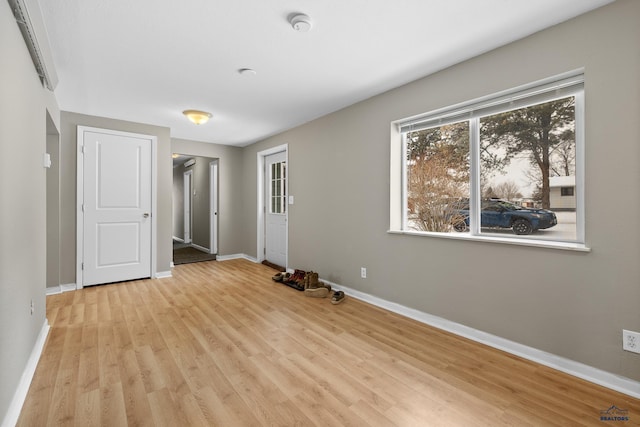 spare room with light wood finished floors and baseboards