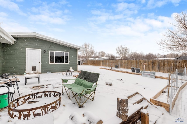 snow covered patio featuring fence