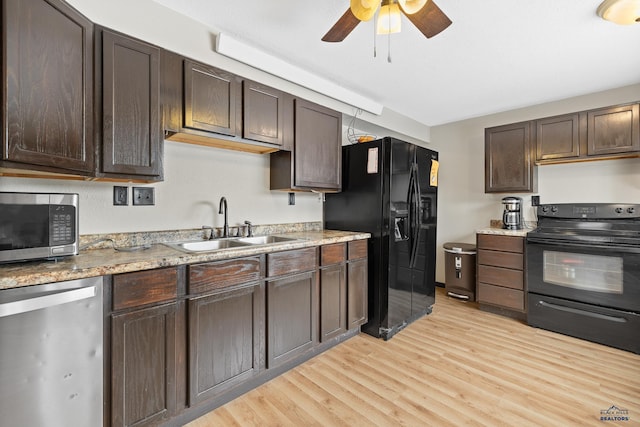 kitchen featuring dark brown cabinets, light wood-type flooring, black appliances, a ceiling fan, and a sink