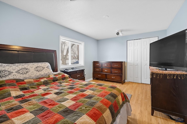 bedroom with a closet and light wood finished floors