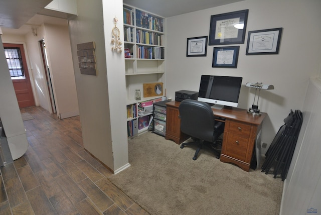 home office featuring baseboards and wood finished floors