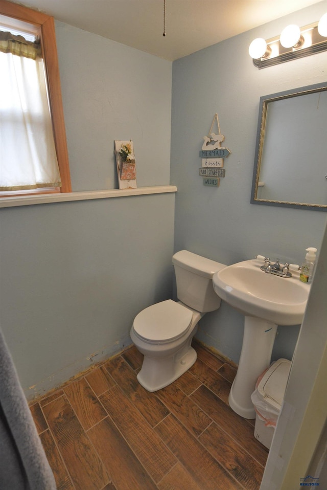 bathroom featuring toilet and wood tiled floor