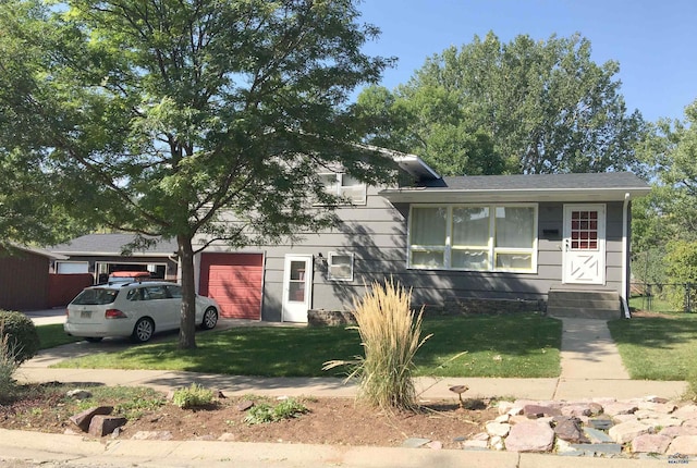 split level home featuring a front yard and an attached garage