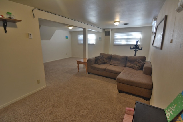 carpeted living room with visible vents and baseboards