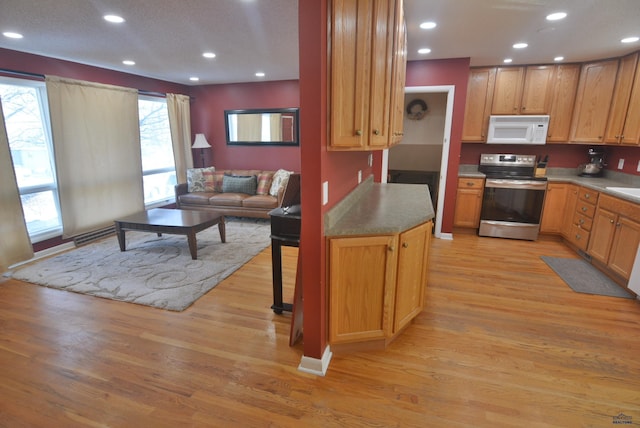 kitchen featuring light wood-type flooring, open floor plan, recessed lighting, stainless steel electric range, and white microwave