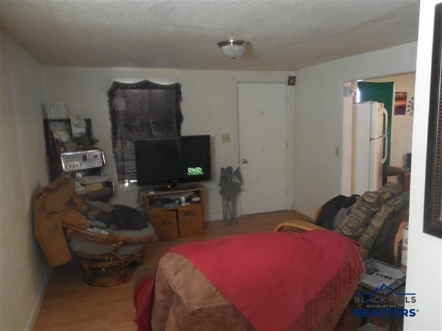 710 Haines Ave, Rapid City, SD 57701 - bedroom featuring wood finished floors and freestanding refrigerator