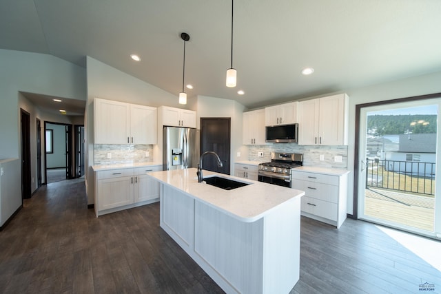 kitchen with light countertops, lofted ceiling, stainless steel appliances, white cabinetry, and a sink