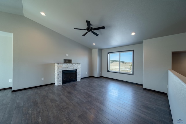 unfurnished living room with a fireplace, dark wood-type flooring, baseboards, and vaulted ceiling