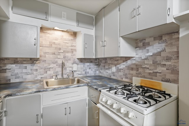 kitchen featuring white gas stove, backsplash, and a sink