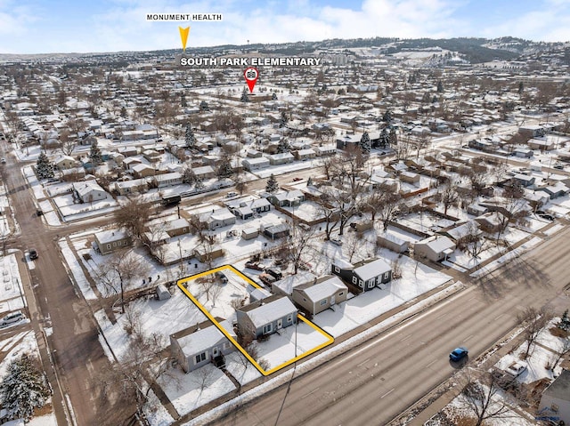 snowy aerial view with a residential view