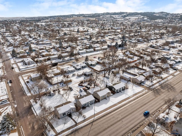 snowy aerial view with a residential view