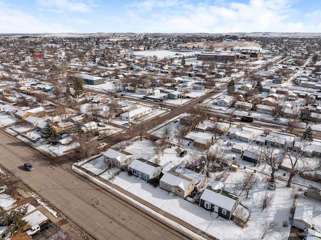 snowy aerial view featuring a residential view